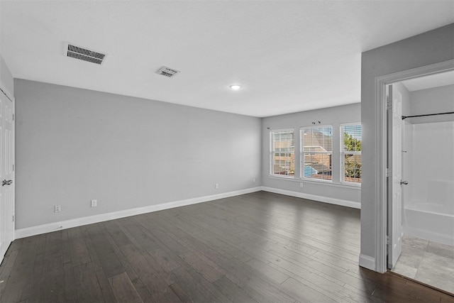 unfurnished room with dark hardwood / wood-style floors