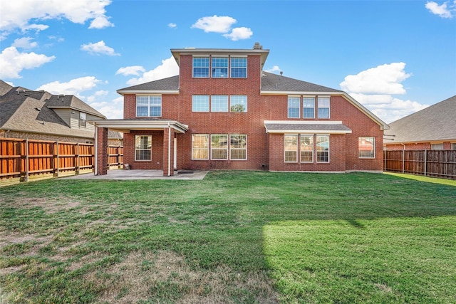 back of house with a patio and a yard