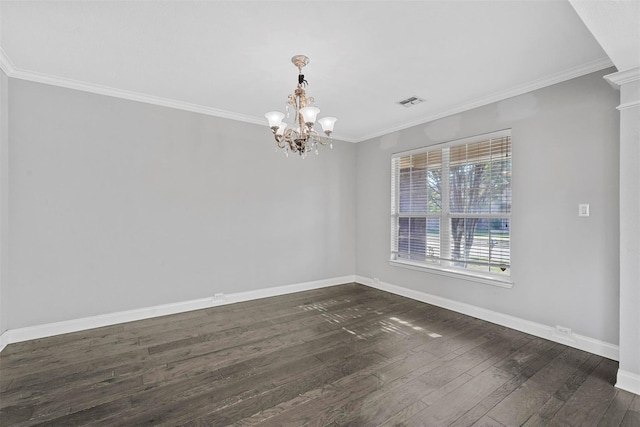 spare room with ornamental molding, dark wood-type flooring, and a chandelier