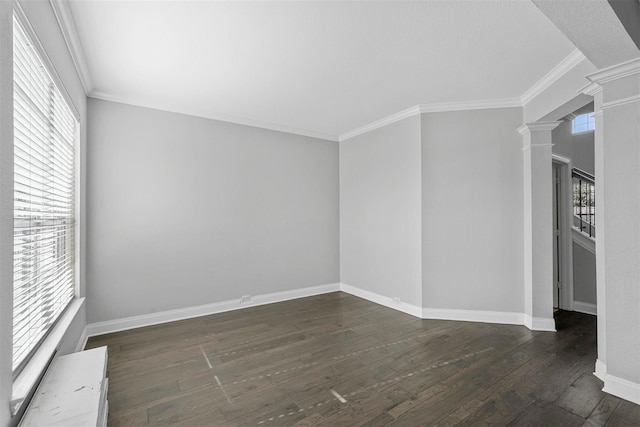 unfurnished room featuring crown molding, dark wood-type flooring, and decorative columns