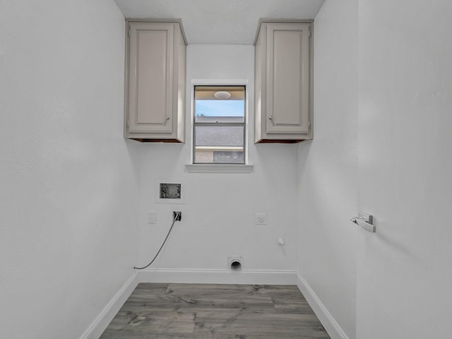 laundry room featuring cabinets, hookup for a washing machine, hardwood / wood-style flooring, hookup for an electric dryer, and hookup for a gas dryer