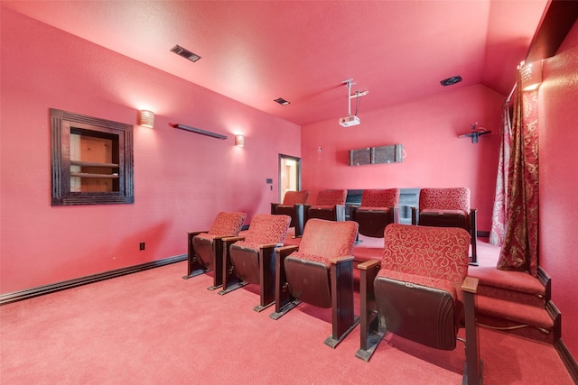 carpeted home theater with lofted ceiling