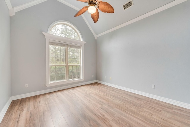 empty room with lofted ceiling, crown molding, light hardwood / wood-style floors, and ceiling fan