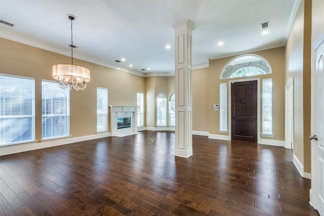 entryway featuring decorative columns, plenty of natural light, and dark hardwood / wood-style flooring