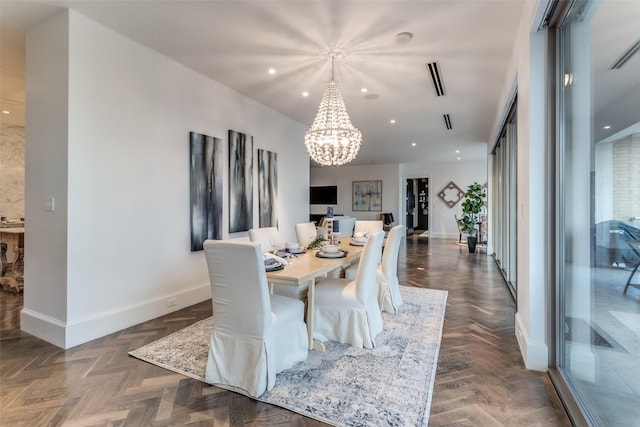 dining area with dark parquet flooring and a notable chandelier