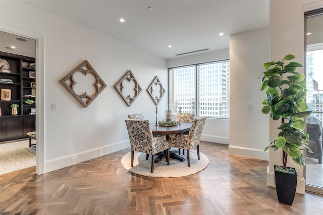 dining space featuring parquet floors