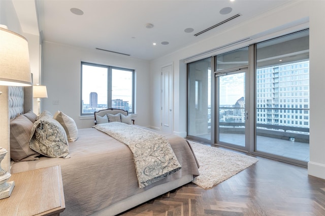 bedroom with dark parquet flooring and access to outside