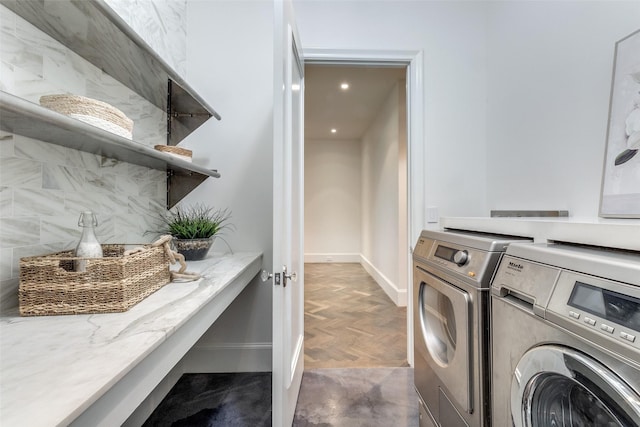 laundry room featuring washing machine and dryer and dark parquet floors