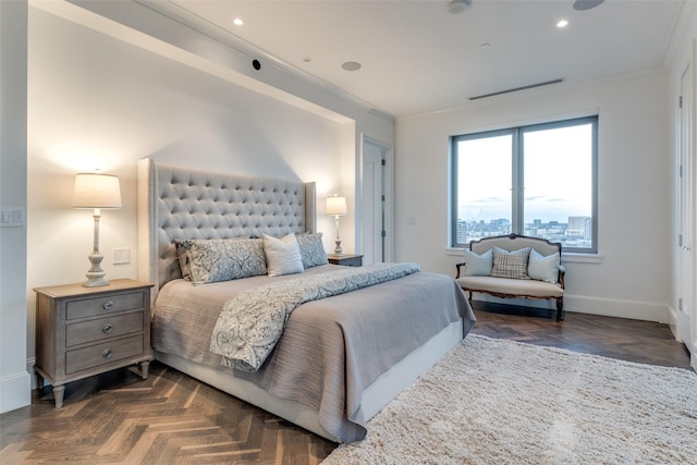 bedroom with crown molding and dark parquet floors