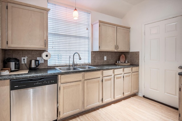 kitchen with dishwasher, sink, light hardwood / wood-style flooring, and backsplash