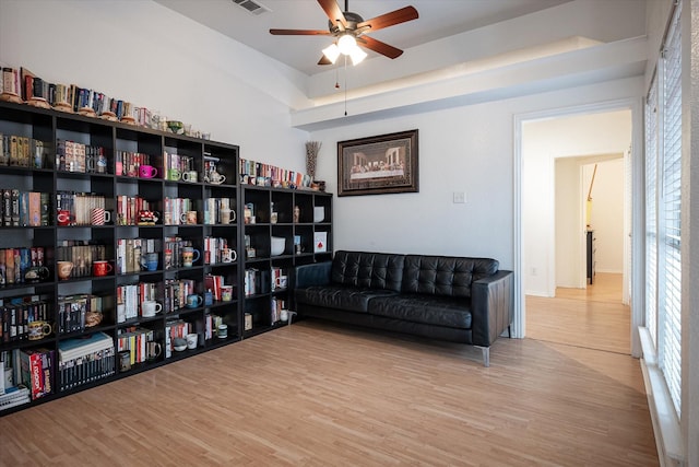 living area featuring ceiling fan and light hardwood / wood-style floors