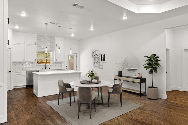 dining area with sink and dark hardwood / wood-style flooring