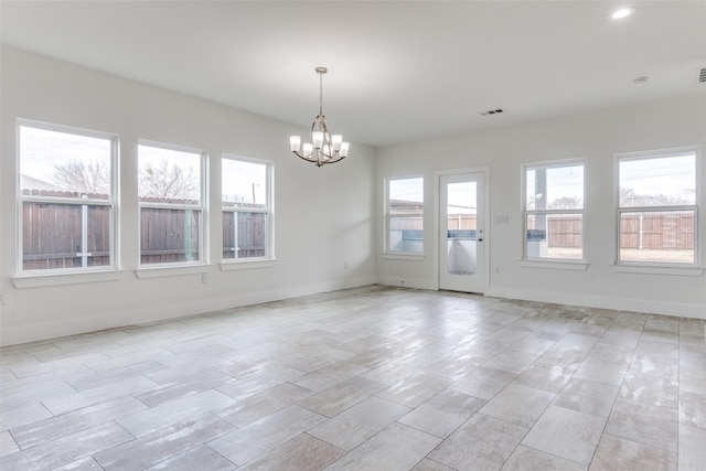 unfurnished room featuring recessed lighting, visible vents, baseboards, and an inviting chandelier