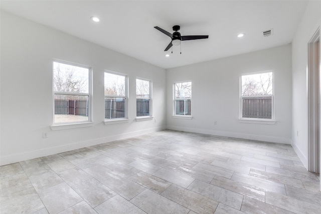 empty room featuring recessed lighting, visible vents, and baseboards