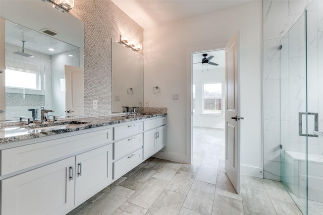 bathroom featuring double vanity, visible vents, a stall shower, a sink, and ceiling fan