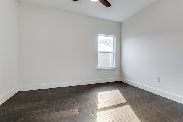 empty room featuring ceiling fan, baseboards, and dark wood-type flooring