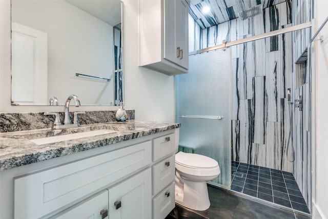 full bathroom featuring a stall shower, tile patterned flooring, vanity, and toilet