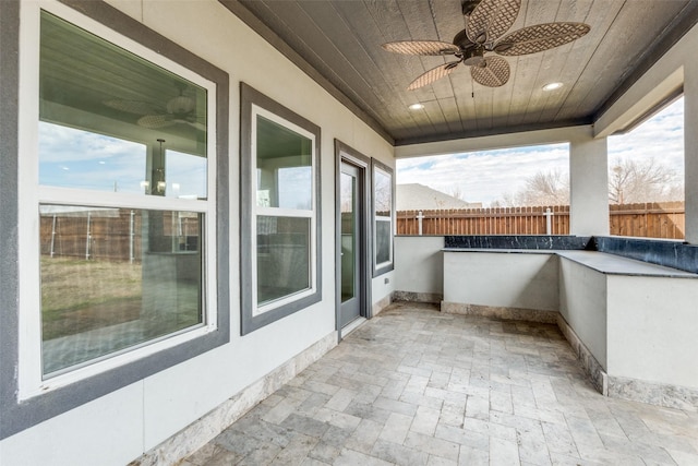 view of patio / terrace with fence and a ceiling fan