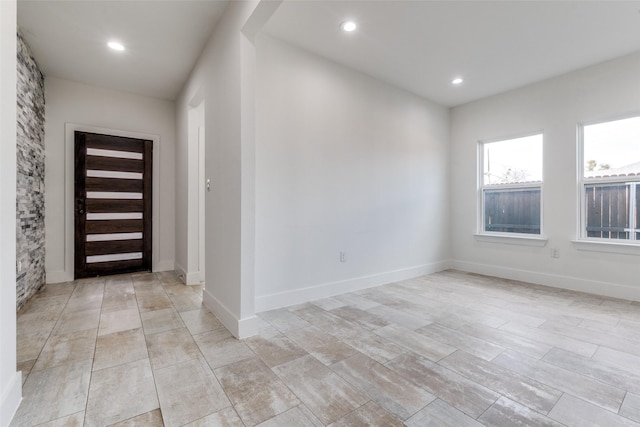 entryway with recessed lighting and baseboards