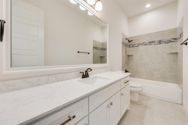 full bathroom with vanity, tile patterned floors, toilet, and tiled shower / bath