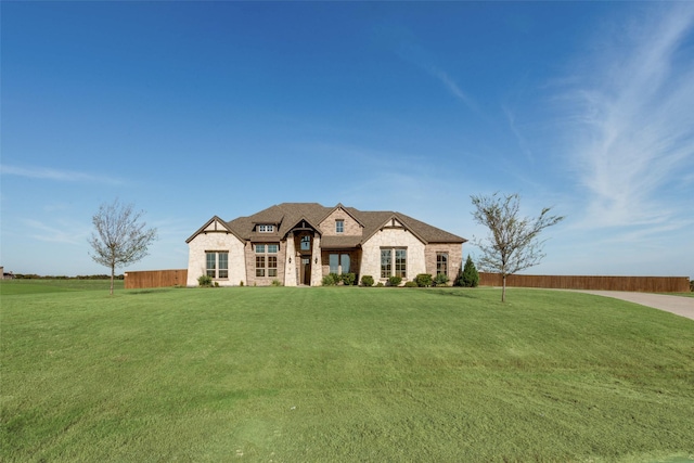 french provincial home featuring a front lawn