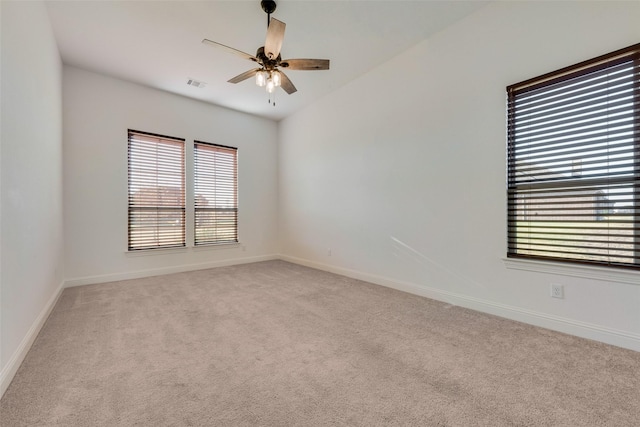 carpeted spare room featuring ceiling fan