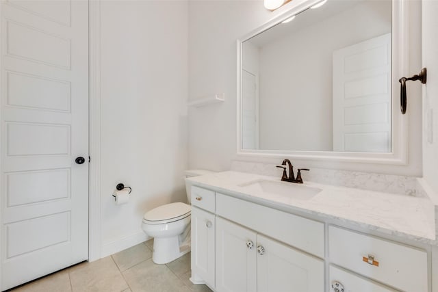 bathroom with vanity, tile patterned floors, and toilet