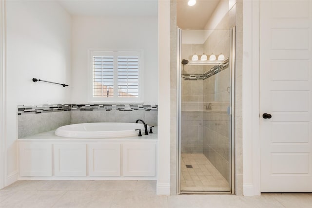 bathroom featuring tile patterned floors and shower with separate bathtub