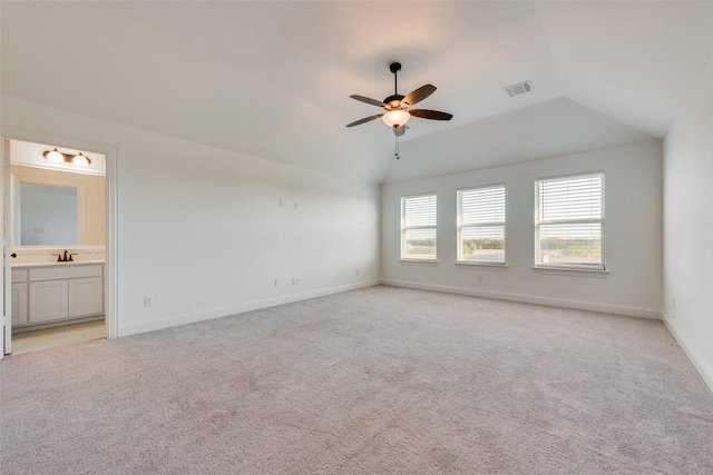 spare room with lofted ceiling, sink, light carpet, and ceiling fan