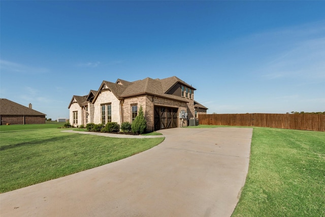 view of front facade with central AC, a garage, and a front yard