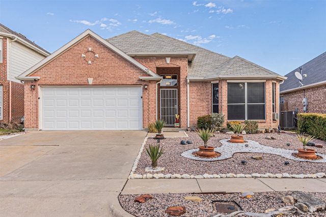 view of front of property featuring a garage and central AC