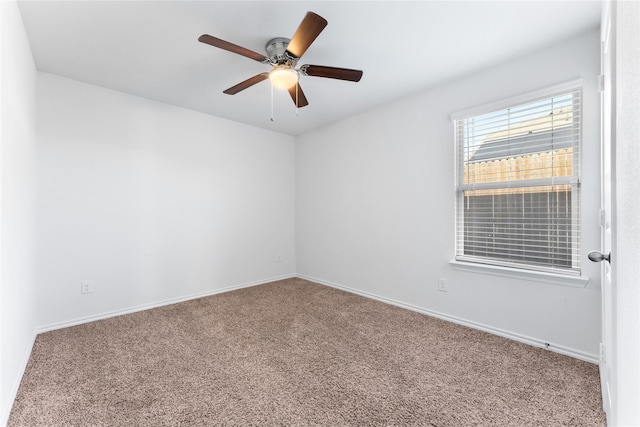 spare room featuring ceiling fan and carpet floors