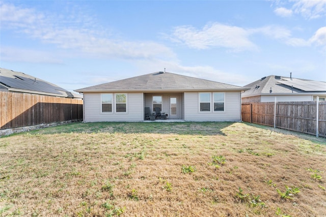 rear view of house featuring a lawn