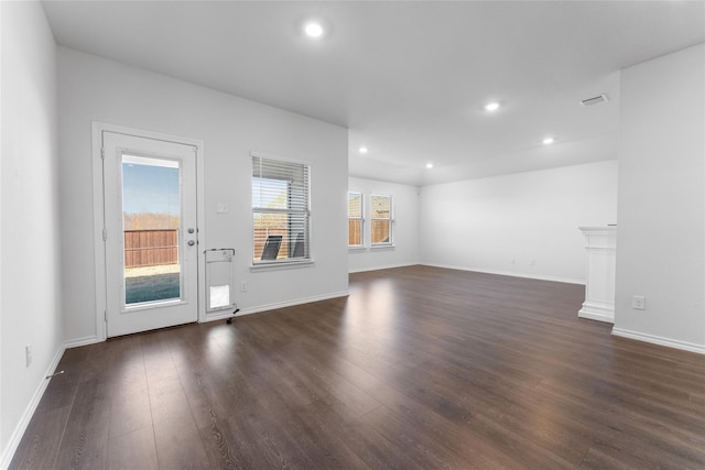 unfurnished living room with dark wood-type flooring