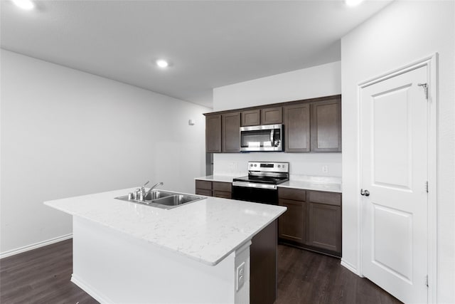 kitchen featuring stainless steel appliances, sink, dark hardwood / wood-style flooring, and an island with sink