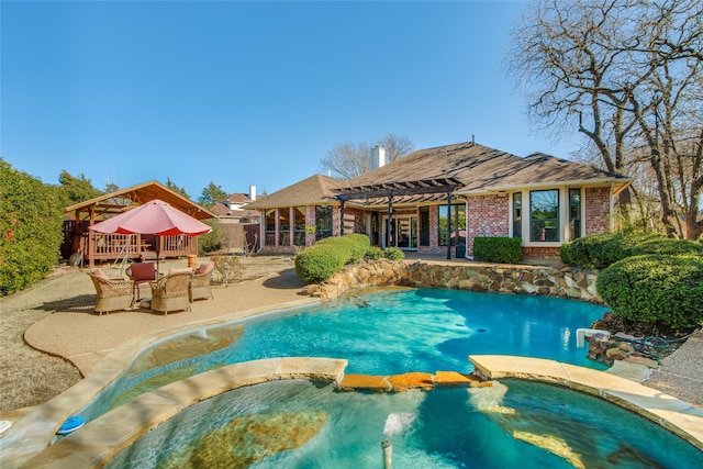 view of pool with an in ground hot tub, a pergola, and a patio area