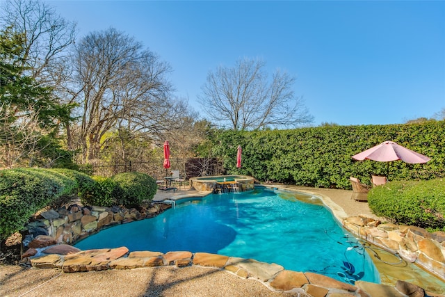 view of swimming pool featuring an in ground hot tub and a patio area