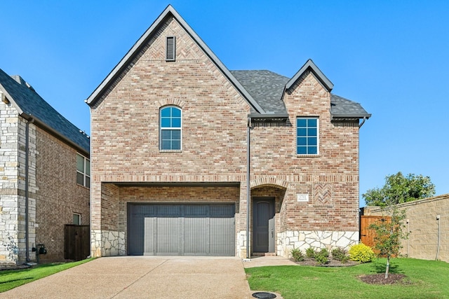 view of front of house with a garage and a front yard