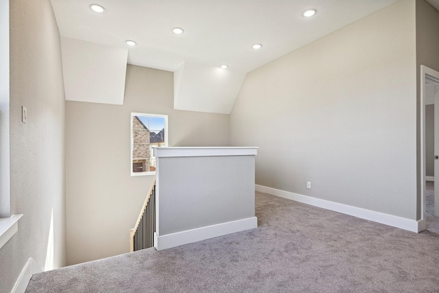 interior space with light colored carpet and lofted ceiling