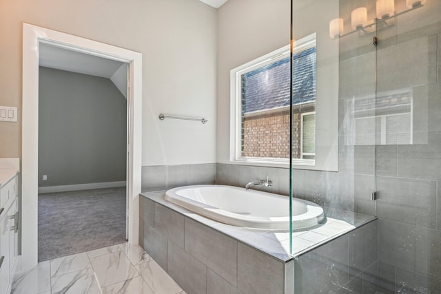 bathroom with vanity and shower with separate bathtub