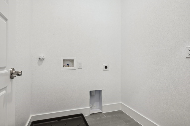 clothes washing area featuring dark tile patterned floors, electric dryer hookup, washer hookup, and hookup for a gas dryer