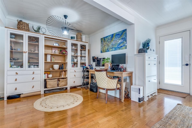 office space with crown molding and light wood-type flooring