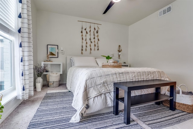 bedroom featuring ceiling fan and carpet