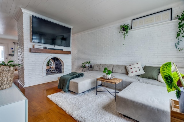 living room featuring brick wall, dark wood-type flooring, wooden ceiling, and a fireplace