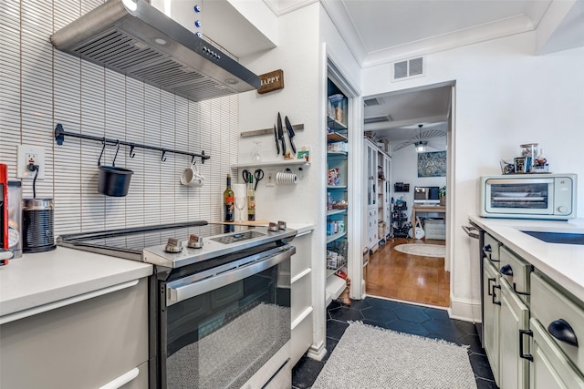 kitchen featuring dark tile patterned floors, ornamental molding, electric range, and range hood