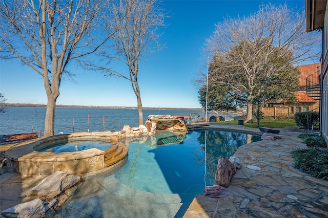 view of pool featuring an in ground hot tub and a water view