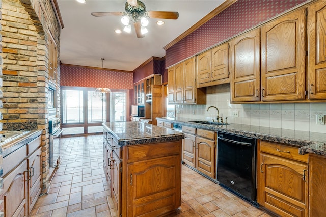 kitchen featuring dark stone countertops, sink, a center island, and black dishwasher