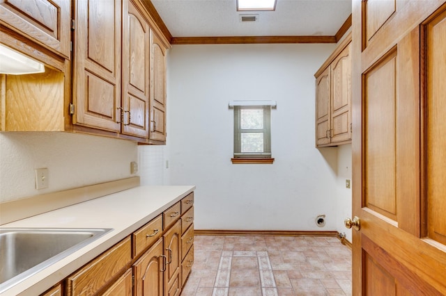 kitchen with crown molding and sink