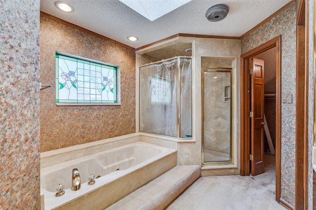 bathroom featuring independent shower and bath, a textured ceiling, and a skylight