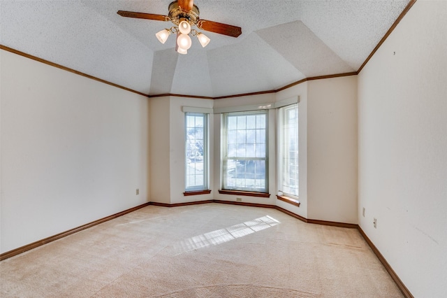 carpeted spare room with ornamental molding, lofted ceiling, and a textured ceiling